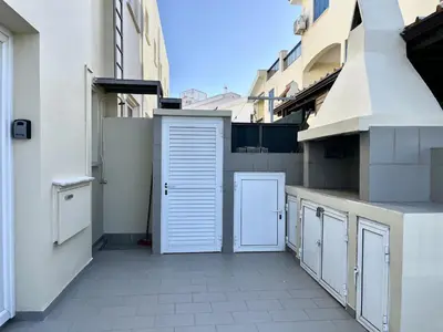 a kitchen with white cabinets on a building at STAY Almyra House in Protaras