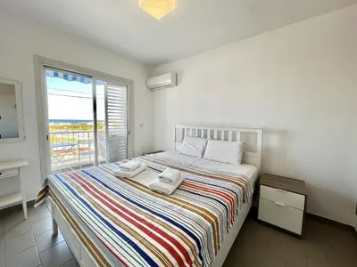 a bedroom with a bed with two towels on it at STAY Almyra House in Protaras