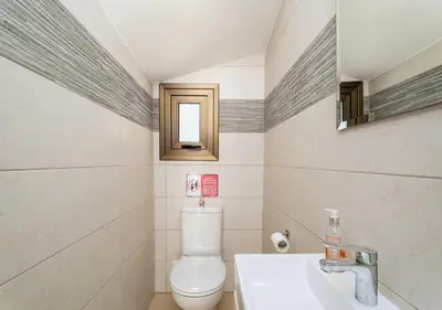 a bathroom with a toilet and a sink and a mirror at Levanda Dreams 8 in Paralimni