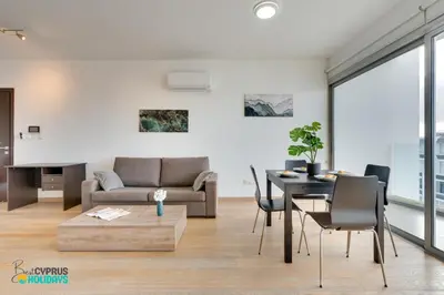 a living room with a couch and a table at The lighthouse 1 bedroom 604 in Larnaka