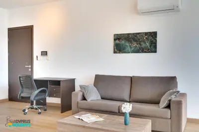 a living room with a couch and a desk at The lighthouse 1 bedroom 604 in Larnaka