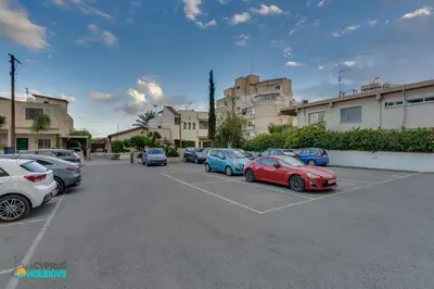 a group of cars parked in a parking lot at The lighthouse 1 bedroom 604 in Larnaka