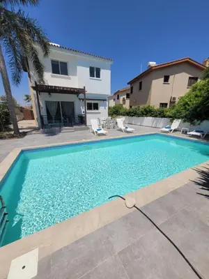 a swimming pool in front of a house at Ayia Napa Marina Luxury Villas - Aquamarine in Ayia Napa