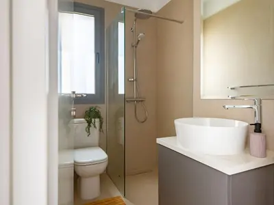 a bathroom with a sink and a toilet and a shower at Sanders Limassol Park - Full Building in Trakhoni