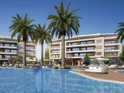 a swimming pool with palm trees in front of a building at Sanders Limassol Park - Full Building in Trakhoni