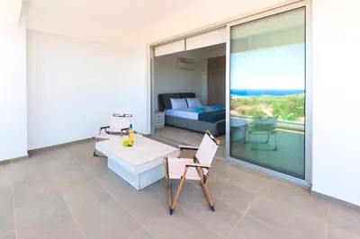 a room with a balcony with a bed and a table and chairs at Elite Panoramic View 3Bdr Villa with pool Ayia Napa in Ayia Napa
