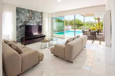 a living room with two couches and a pool at Elite Panoramic View 3Bdr Villa with pool Ayia Napa in Ayia Napa