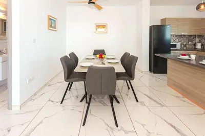 a dining room with a table and chairs in a kitchen at Royal Panoramic View 3Bdr Villa with pool Ayia Napa in Ayia Napa
