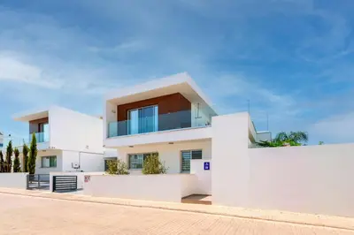 a white house with a balcony on top of it at Royal Panoramic View 3Bdr Villa with pool Ayia Napa in Ayia Napa