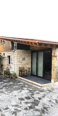 a brick building with a bench in front of it at The Zephyr House in Pyrgos