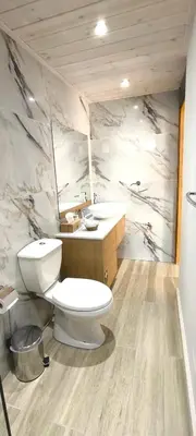 a bathroom with a toilet and a sink at The Zephyr House in Pyrgos