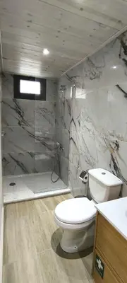 a bathroom with a toilet and a shower at The Zephyr House in Pyrgos