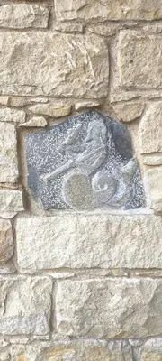 a stone wall with a statue of a bird on it at The Zephyr House in Pyrgos