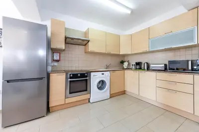 a kitchen with a stainless steel refrigerator and a dishwasher at Nissi Apartment #102 in Ayia Napa