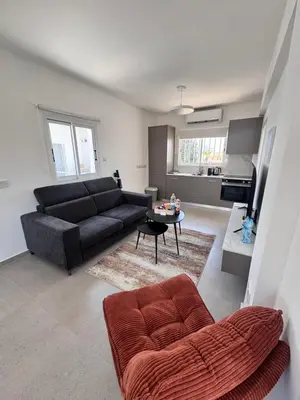 a living room with a couch and a table at Dhekelia Beach house - Pyla, Larnaca in Pyla