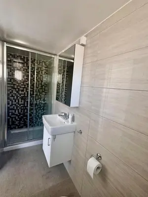 a bathroom with a sink and a glass shower at Dhekelia Beach house - Pyla, Larnaca in Pyla