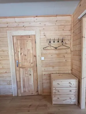 a room with a wooden wall with a door at Kellaki Relaxation Cottage in Kellaki