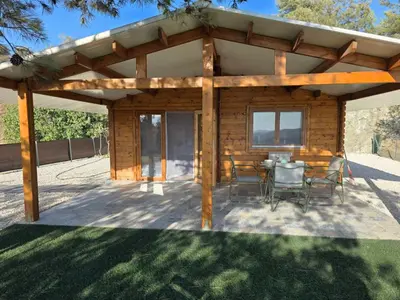 a wooden pergola with a table and chairs at Kellaki Relaxation Cottage in Kellaki