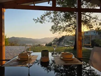 a table with two glasses and a plate of food at Kellaki Relaxation Cottage in Kellaki