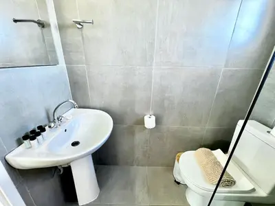 a bathroom with a sink and a toilet at STAY Capari Light Apartment in Protaras