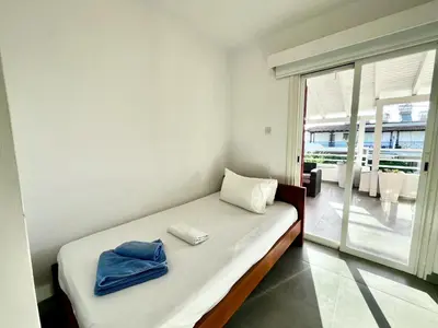 a bedroom with a bed with a towel on it at STAY Capari Light Apartment in Protaras