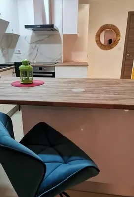 a green tea pot sitting on a counter in a kitchen at Nestia Apartment in Yermasoyia