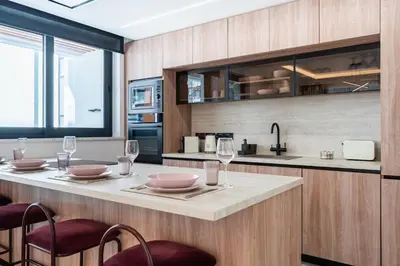 a kitchen with a table with wine glasses on it at Densho 2-Bedroom Luxury Apartment in Larnaka