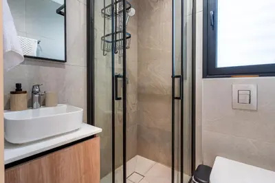 a bathroom with a sink and a shower at Densho 2-Bedroom Luxury Apartment in Larnaka