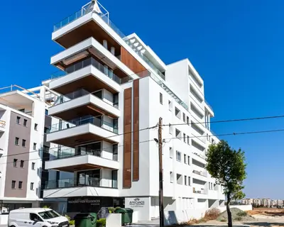 an apartment building with balconies on a street at Densho 2-Bedroom Luxury Apartment in Larnaka