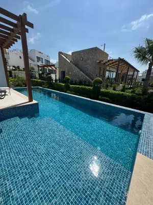 a swimming pool with blue tiles in a building at Mykonos Homes Villa in Aglantzia