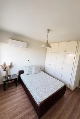a bedroom with a bed and a table in it at Stay in Harmony in Paralimni