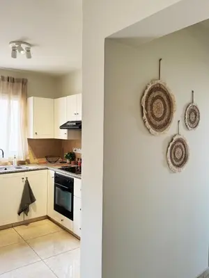 a kitchen with white cabinets and white appliances at Stay in Harmony in Paralimni