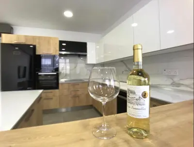 a bottle of wine sitting next to a wine glass at Eden Garden 2 bedroom Alsancak in Nicosia International Airport