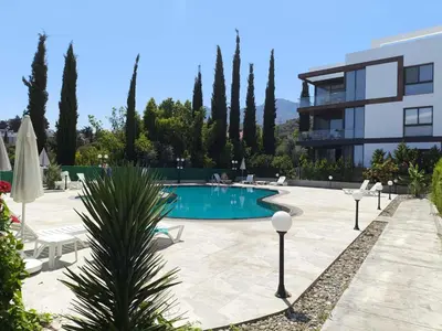 a swimming pool in front of a building at Eden Garden 2 bedroom Alsancak in Nicosia International Airport