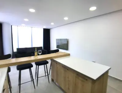 an office with a bar with stools and a table with a wine glass at Eden Garden 2 bedroom Alsancak in Nicosia International Airport