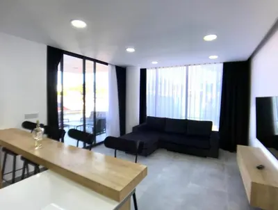 a living room with a couch and a table at Eden Garden 2 bedroom Alsancak in Nicosia International Airport