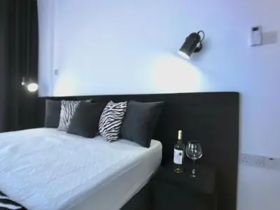 a bed with a bottle and two glasses of wine at Eden Garden 2 bedroom Alsancak in Nicosia International Airport