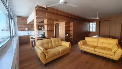 a living room with two yellow chairs and a kitchen at The C Suite - Business & Leisure in Nicosia in Nicosia