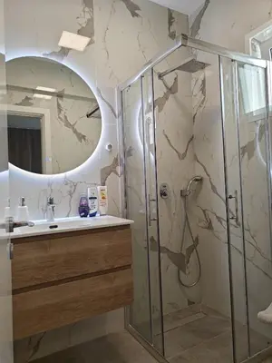 a bathroom with a shower and a sink at Brand new sea view walking distance to the sea 200m in Limassol