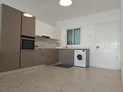 a kitchen with a washer and a washing machine at Brand new sea view walking distance to the sea 200m in Limassol