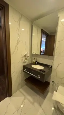 a bathroom with a sink and a mirror at Long Beach, İskele, Grand Sapphire Resort - Pool View Luxury Studio in Paralimni