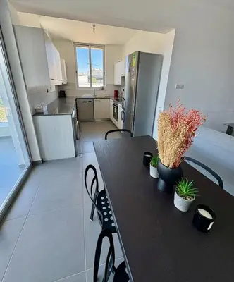 a kitchen with a table with plants on it at Mariam Court 302 in Larnaka