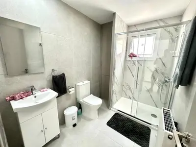a bathroom with a toilet and a shower and a sink at Home in the Hills in Limassol
