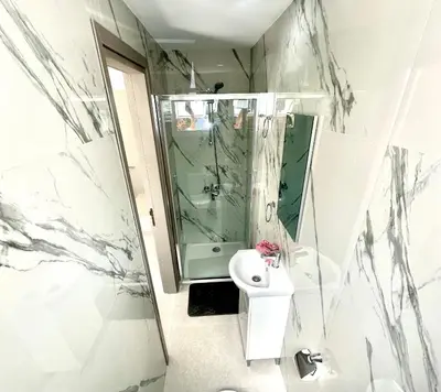 a bathroom with a shower and a toilet and a sink at Home in the Hills in Limassol