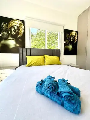 a bed with two blue towels on top of it at Home in the Hills in Limassol