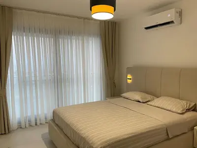 a bedroom with a bed and a large window at Penthouse Blueberry North Cyprus in Kérynia