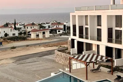 a view of the ocean from the balcony of a building at Penthouse Blueberry North Cyprus in Kérynia