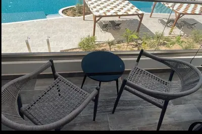 two chairs and a table on top of a balcony at Penthouse Blueberry North Cyprus in Kérynia