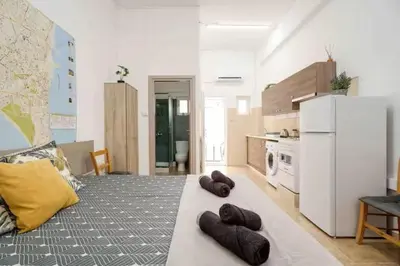 a kitchen with a white refrigerator and two brown pillows at Сozy and traditional - EC Studios in Larnaka