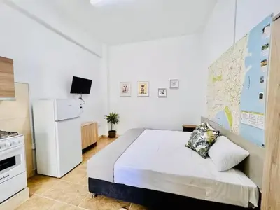 a bedroom with a bed and a map on the wall at Сozy and traditional - EC Studios in Larnaka